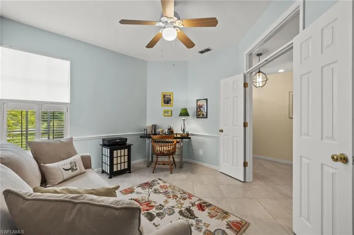 Den featuring transom window over the French doors for flow of light & space.