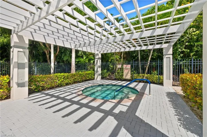 Relax and enjoy the spa, pergola, and surrounding patio