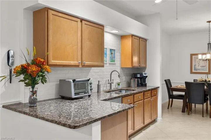 Eat-in kitchen with extra corner cabinetry for storage