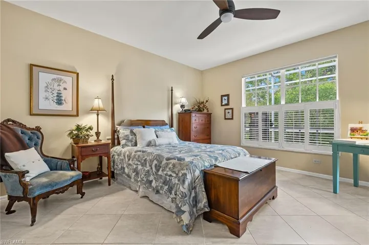 Spacious primary bedroom featuring modern ceiling fan and light