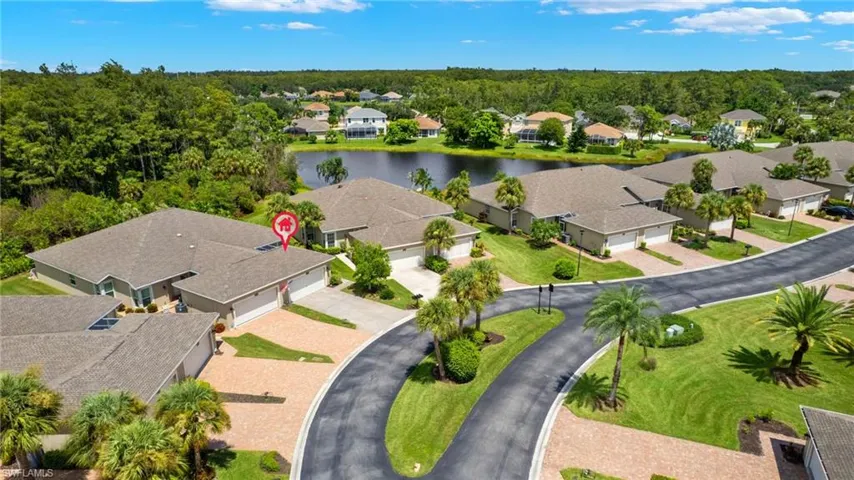 Birds eye view of property with a water view