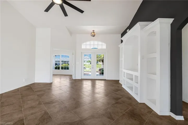 Tiled foyer with french doors and ceiling fan