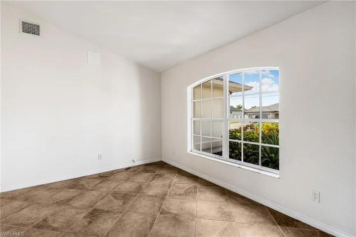 Unfurnished room with vaulted ceiling