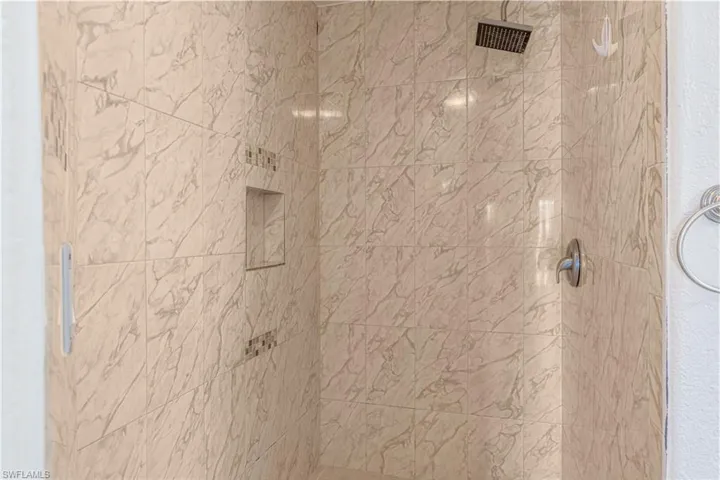Room details with a tile shower
