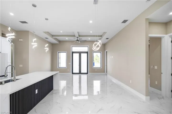 Entrance foyer with light marble finish flooring, recessed lighting, coffered ceiling, and a ceiling fan