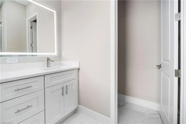 Bathroom with vanity and baseboards