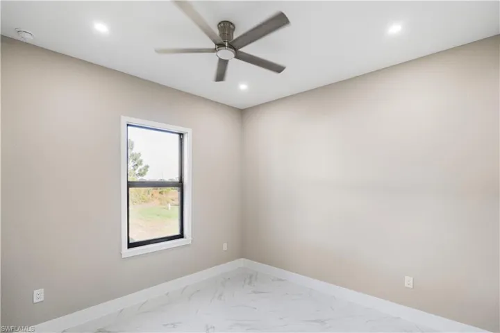 Spare room featuring a ceiling fan, light marble finish floors, recessed lighting, and a smoke detector