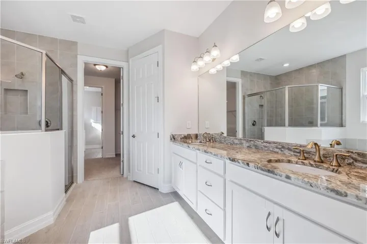 Bathroom featuring walk in shower and vanity