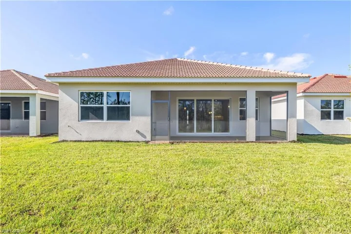Back of house featuring a yard