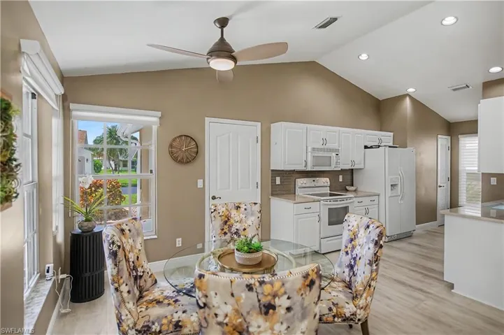 Vaulted ceilings accent an open dining area and kitchen