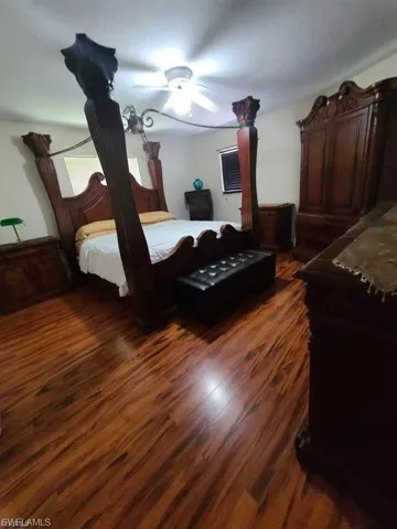 Bedroom featuring dark wood-style floors and a ceiling fan
