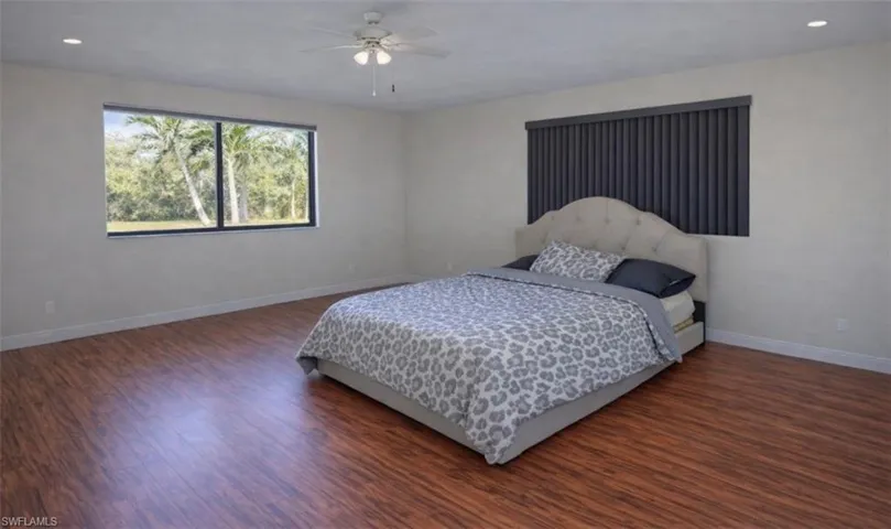 Bedroom featuring recessed lighting, dark wood finished floors, and a ceiling fan