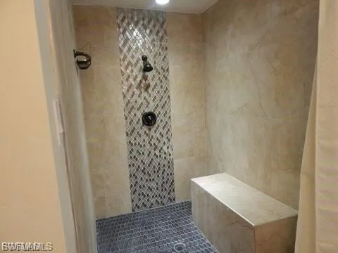 Full bath featuring tiled shower