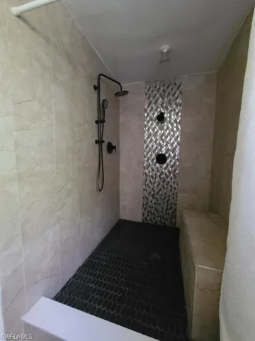 Bathroom featuring tiled shower