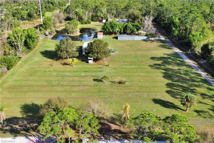 Birds eye view of property with a rural view and a water view