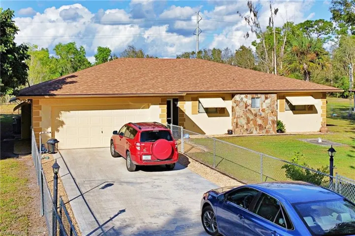 Ranch-style house with a garage and a front yard