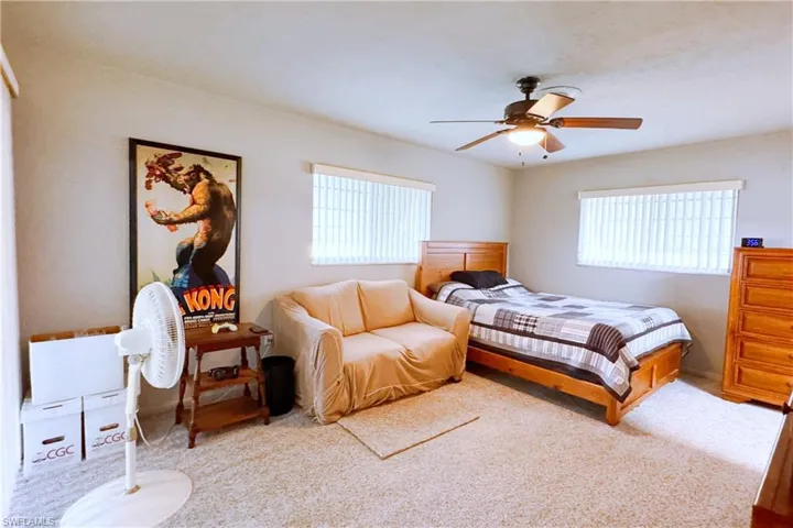 Carpeted bedroom with ceiling fan