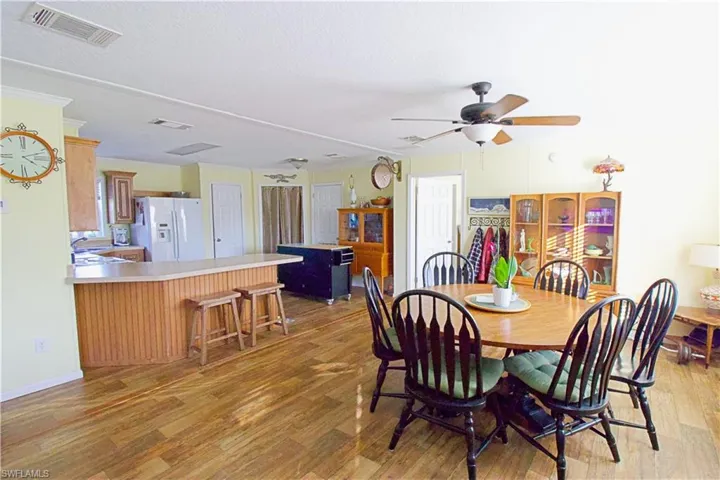 Dining area featuring ceiling fan and light wood-type flooring