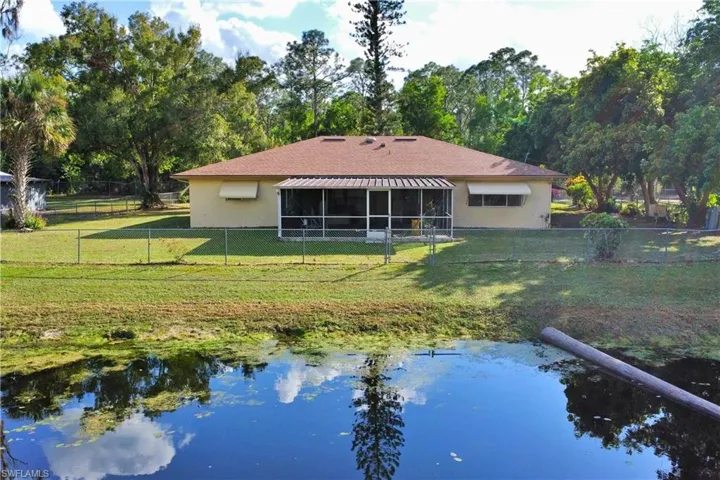 Rear view of house with a yard