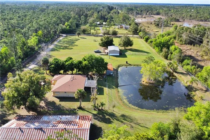 Birds eye view of property with a water view