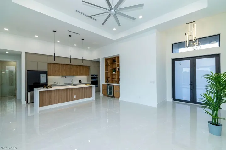 Kitchen featuring modern cabinets, recessed lighting, light countertops, ceiling fan, and decorative light fixtures