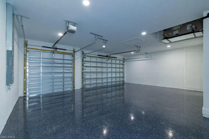 Garage with electric panel and a garage door opener