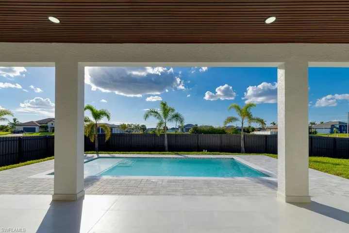 View of pool with a patio, a fenced backyard, and a residential view
