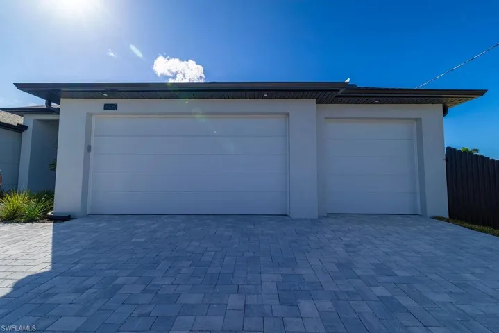 Garage featuring decorative driveway