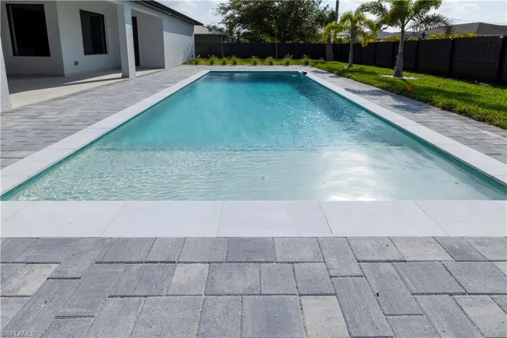 View of pool with a fenced backyard and a patio