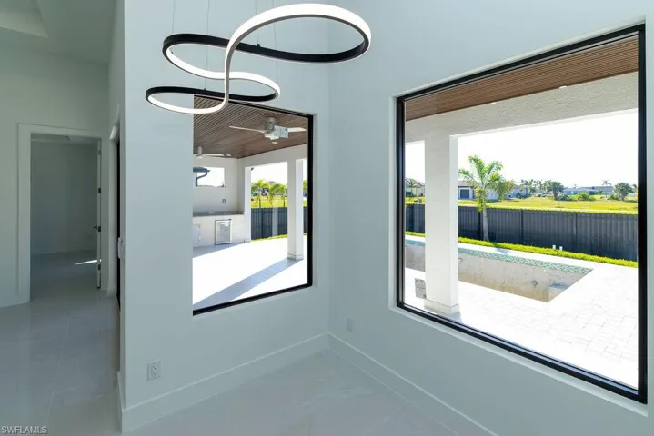 Unfurnished room with ceiling fan and baseboards