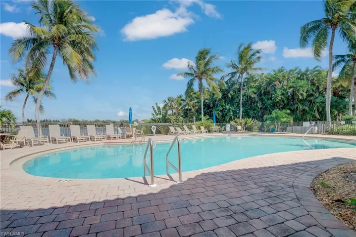 Community pool with a patio