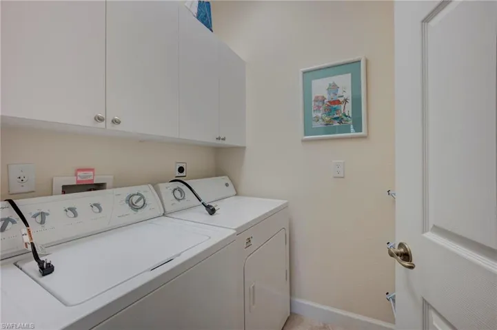 Laundry area with cabinet space and separate washer and dryer