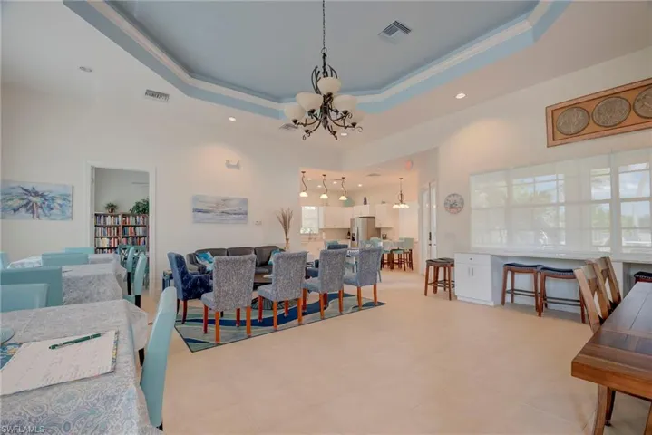 Dining space featuring hanging lights and crown molding