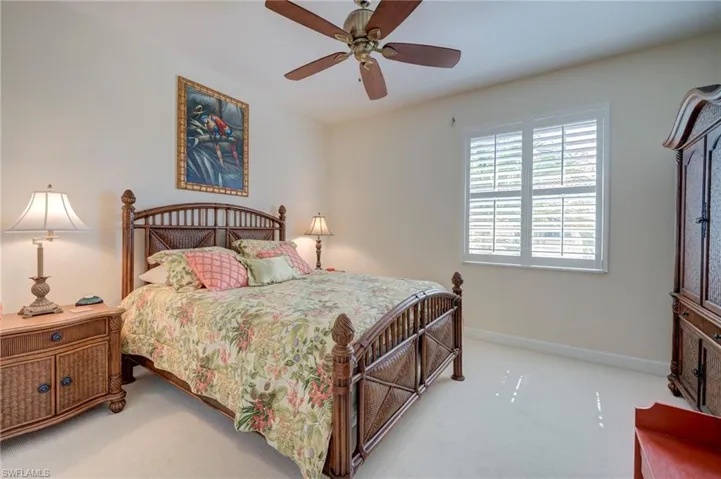Bedroom featuring light carpet and ceiling fan