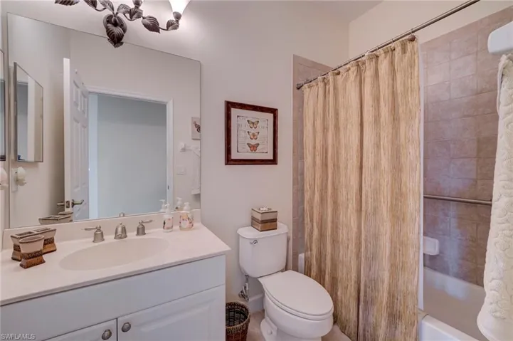 Bathroom with vanity and shower / bathtub combination with curtain