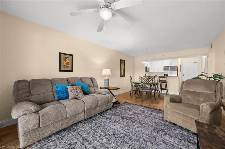 Living area with wood finished floors and a ceiling fan