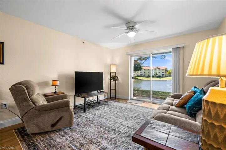 Living area with ceiling fan and wood finished floors