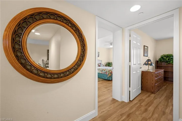Hall with baseboards and light wood finished floors
