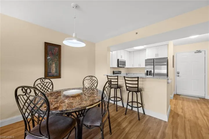 Dining room with light wood-style flooring and baseboards