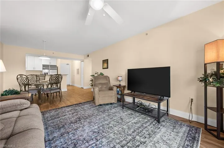 Living area featuring light wood-style flooring and ceiling fan