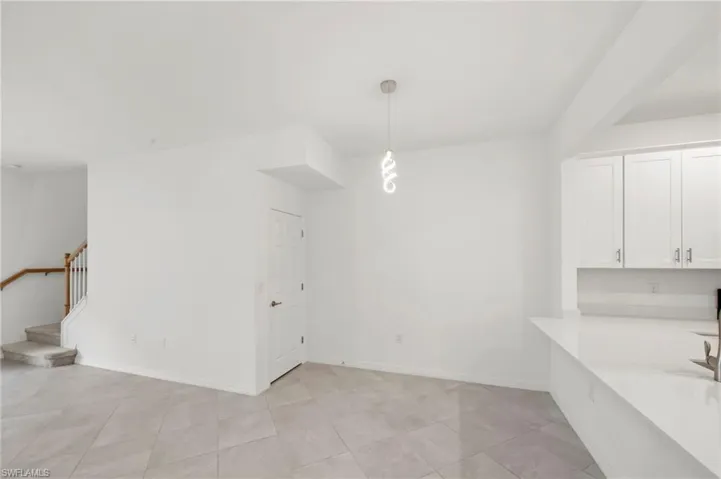 Unfurnished dining area with light tile patterned flooring