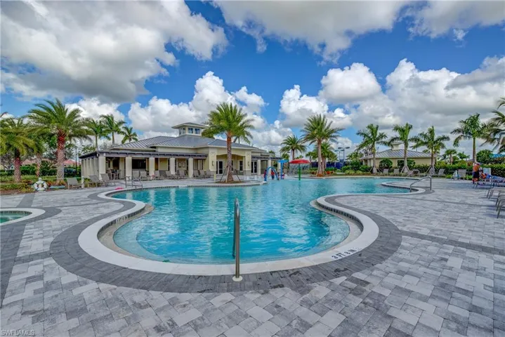 Community pool featuring a patio area and a hot tub