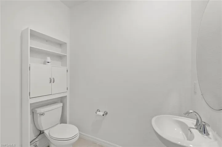 Half bath featuring toilet and a sink