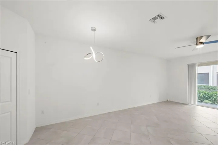 Empty room featuring a ceiling fan and light tile patterned floors