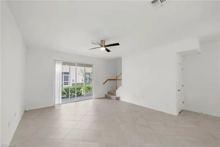 Empty room featuring a ceiling fan and light tile patterned flooring