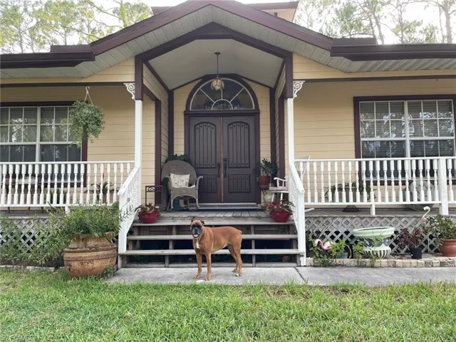 Entrance to property featuring covered porch