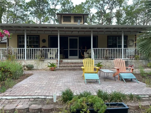 Back of house featuring a porch
