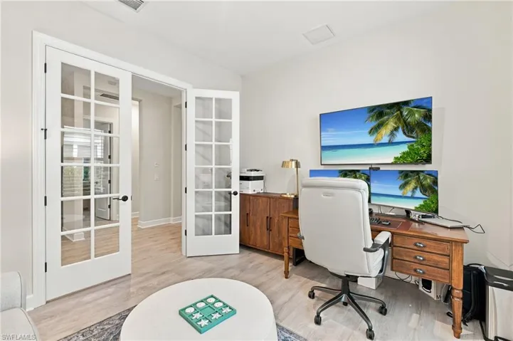 Versatile bonus den with elegant glass French doors, ideal for a home office, guest retreat, or optional nonconforming bedroom.