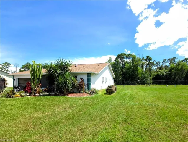 View of grassy yard with an attached garage