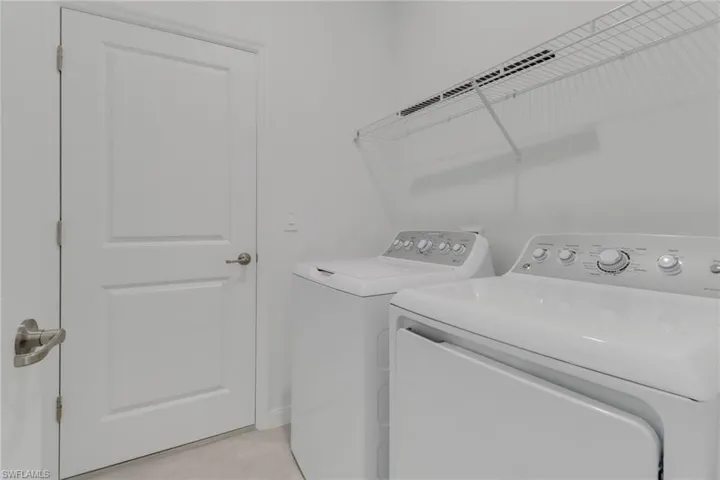 Washroom featuring laundry area and independent washer and dryer